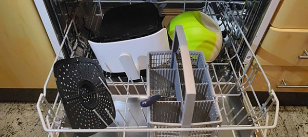 A dishwasher with a few dishes in it

Description automatically generated