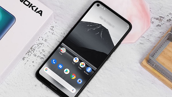 A black cell phone with a mountain on the screen
Description automatically generated