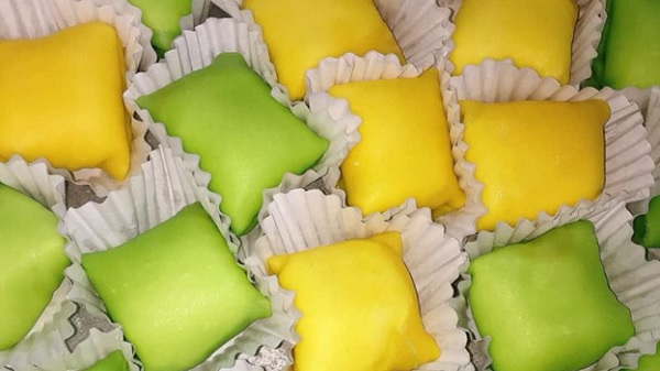 A group of colorful square shaped food
Description automatically generated