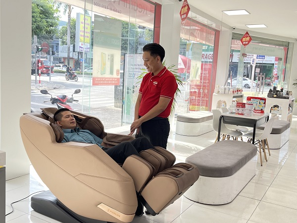 A person standing next to a massage chair
Description automatically generated
