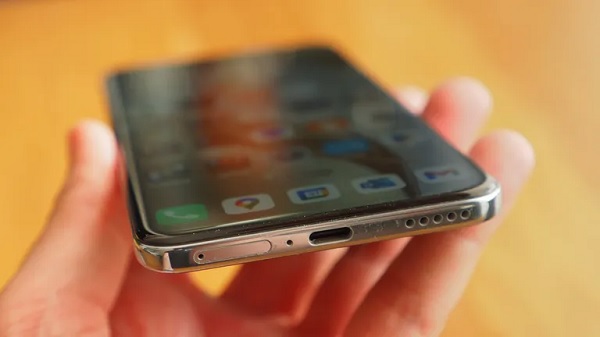 A cell phone with a white cable
Description automatically generated