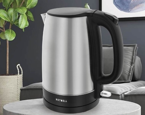 A silver and black kettle on a table

Description automatically generated