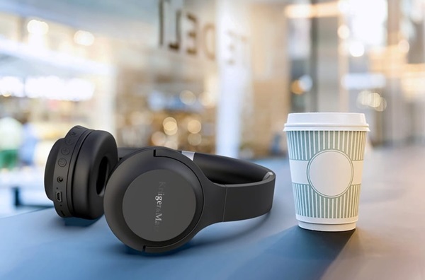 A black headphones and a coffee cup

Description automatically generated