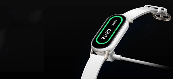 A white watch with a green digital displayDescription automatically generated