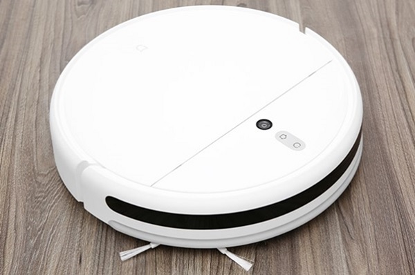 A white circular object on a wood floor
Description automatically generated