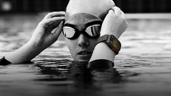 A person in a swimming cap and goggles

Description automatically generated