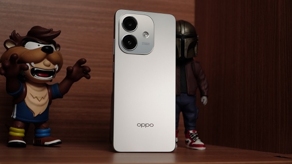 A white cell phone on a silver surface
Description automatically generated